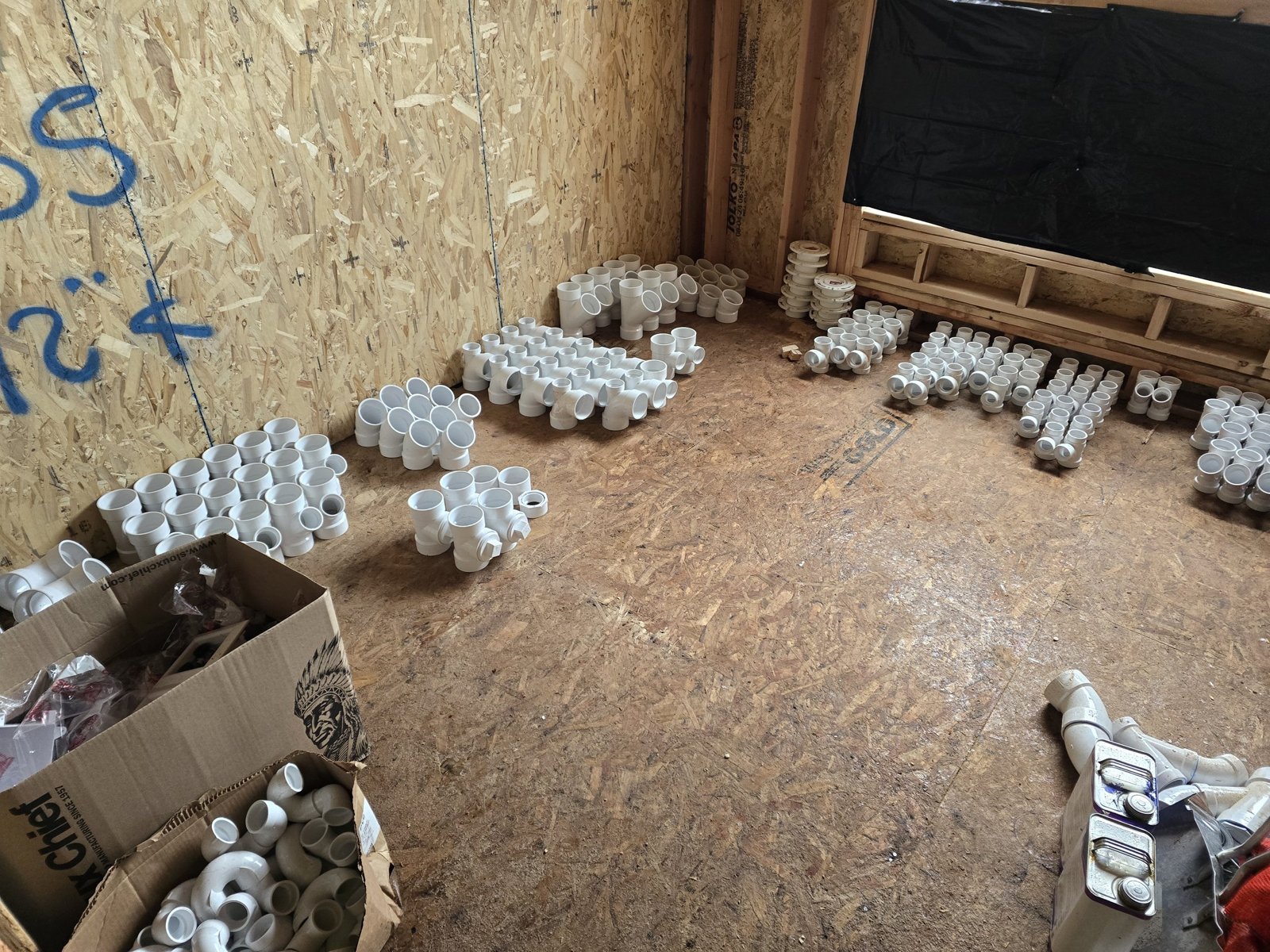Plumbing materials organized for rough-in work.