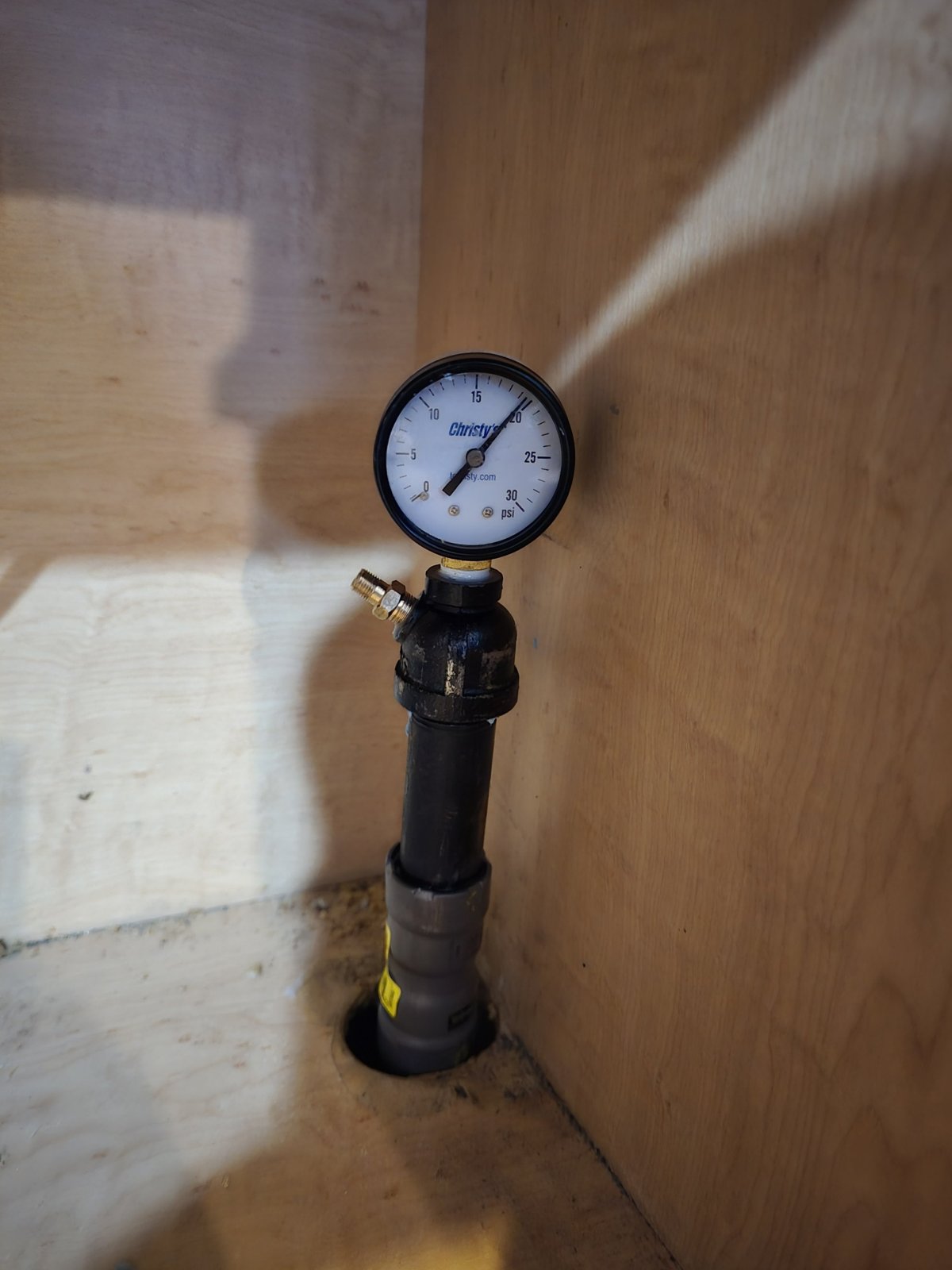 A pressure gauge connected to the piping system.